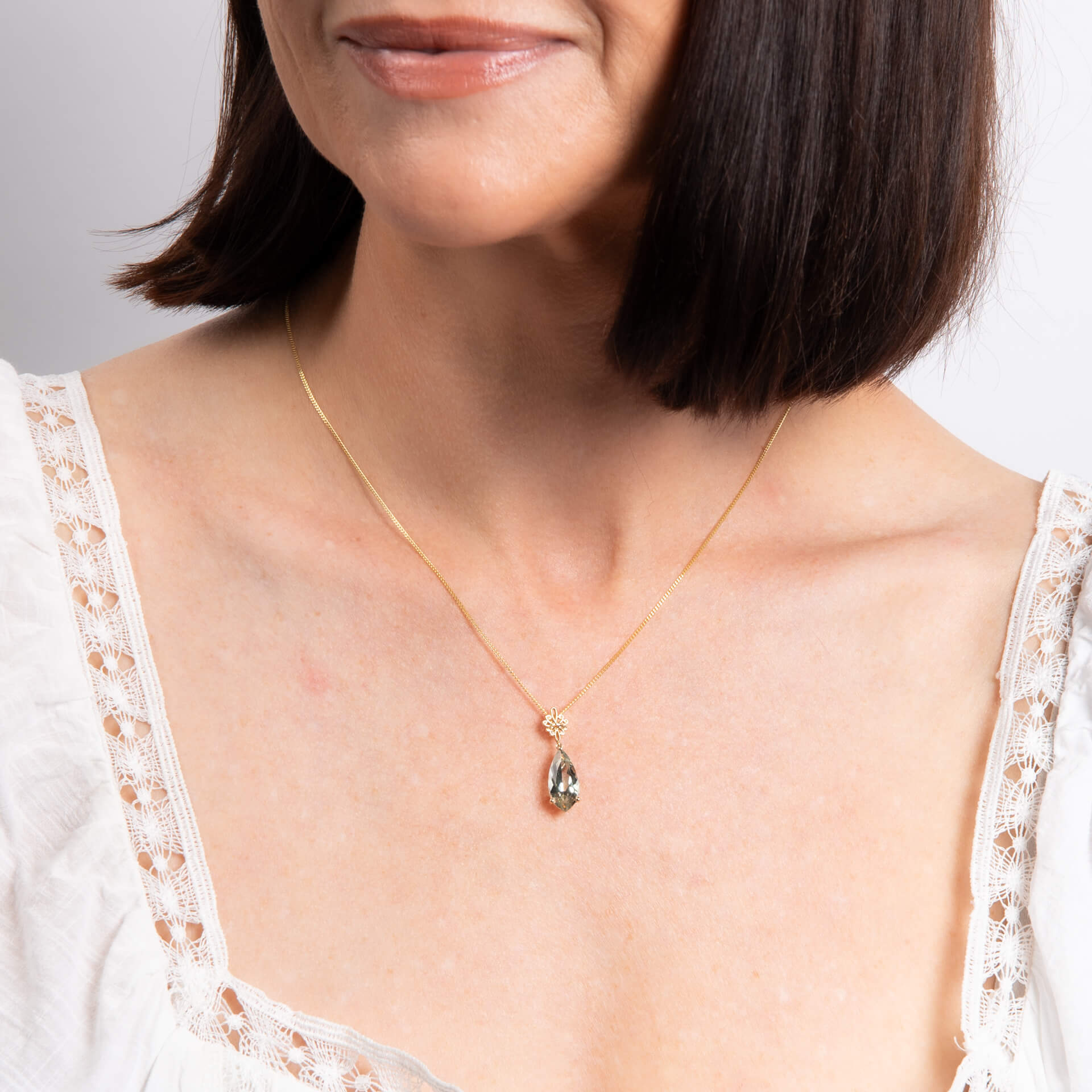 Elements Gold Fancy Cut Green Quartz Drop Pendant with Swirl Detail Bale