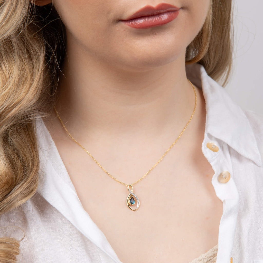 Elements Gold Twist Teardrop Blue Topaz Pendant with Diamond